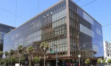 A glass headquarters building at Warriors Way in San Francisco's Mission Bay, home to OpenAI offices.