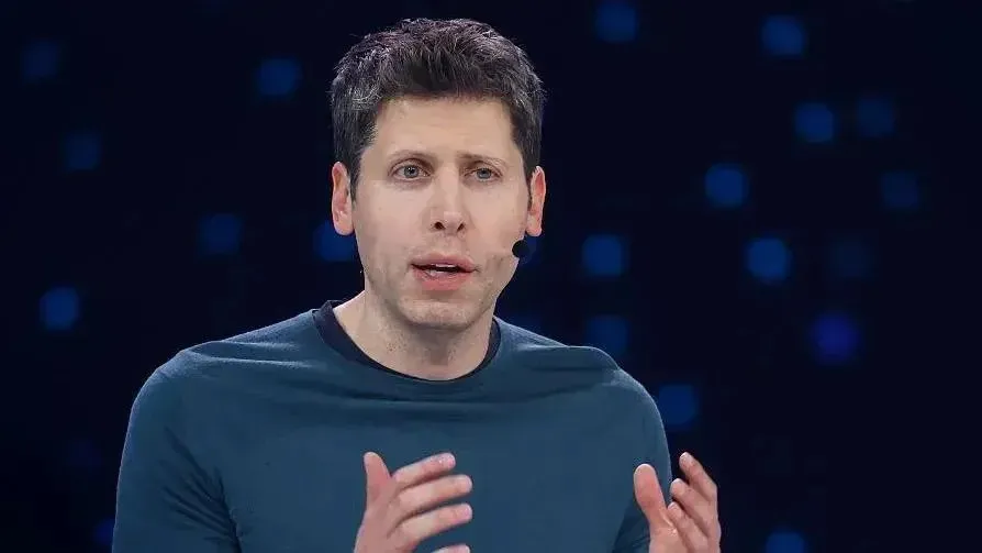 OpenAI chief executive Sam Altman speaking on stage at a company event, wearing a headset microphone.